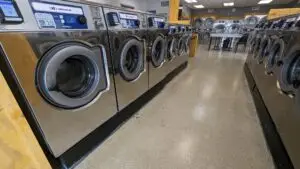 a row of washing machines in a laundry room